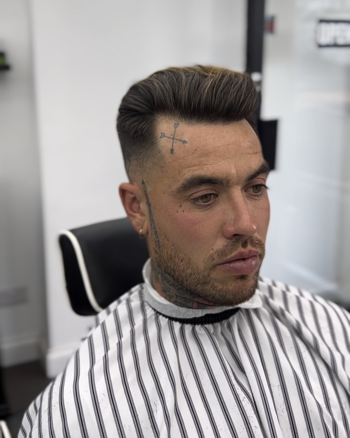 Barber shaping a fresh fade